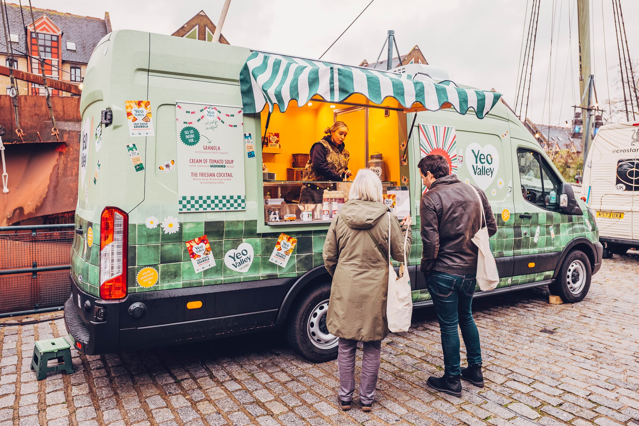 A food and drink festival supplier serving visitors from a branded mobile stand